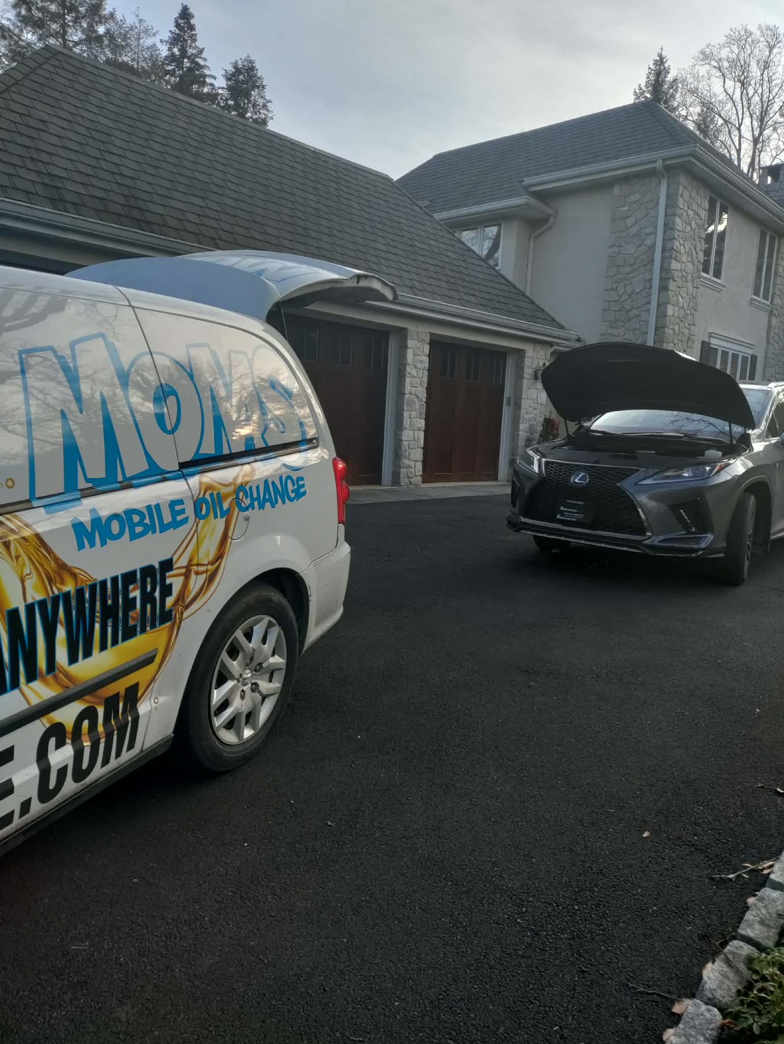 MOMS Mobile Oil Change van performing a full synthetic oil change at a customer driveway