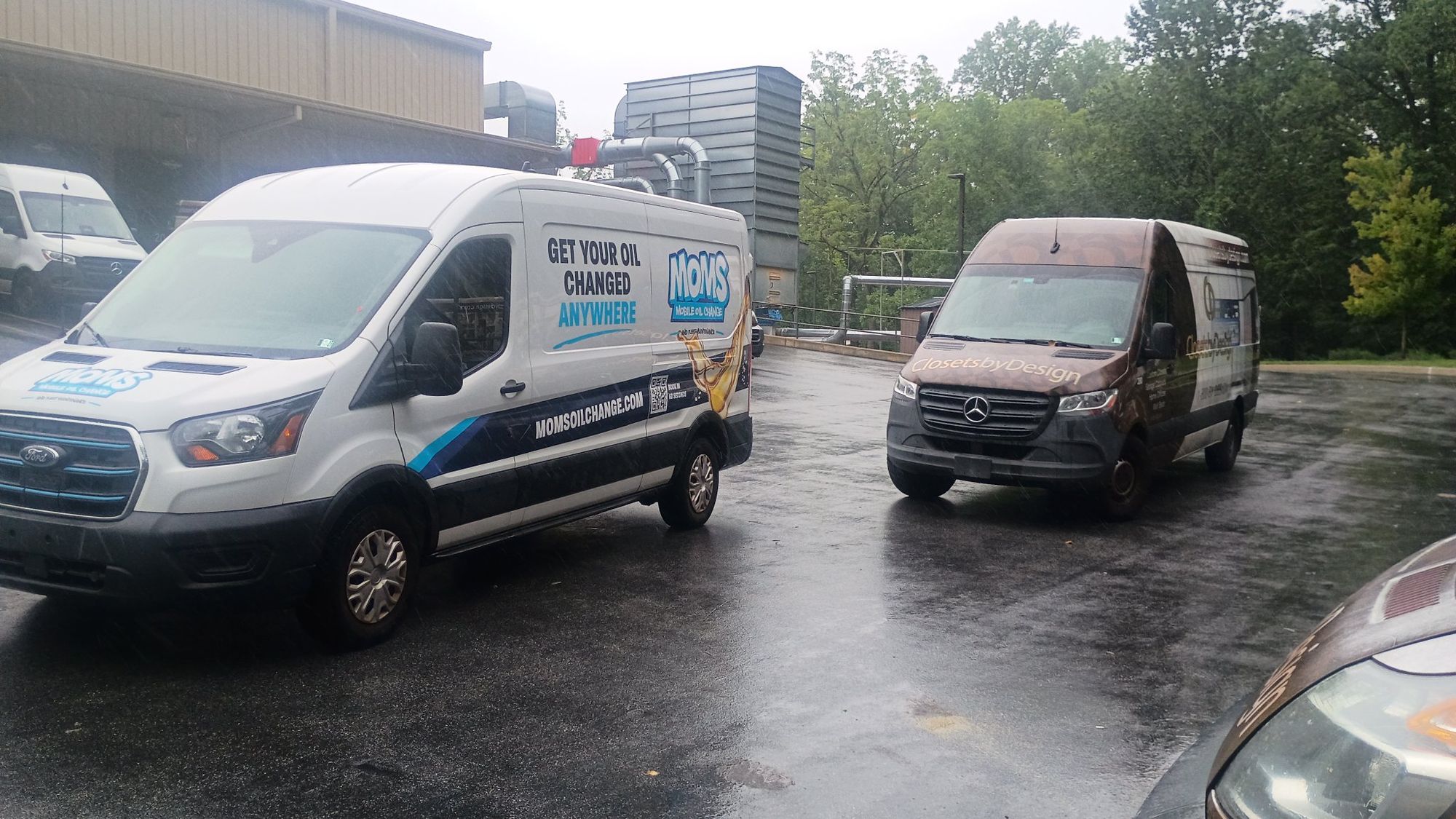 The MOMS Ford Transit van at a fleet customer's lot beside one of the customer's vans